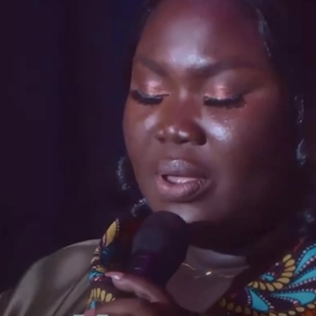 Close-up of Mercy Sinclear with a microphone