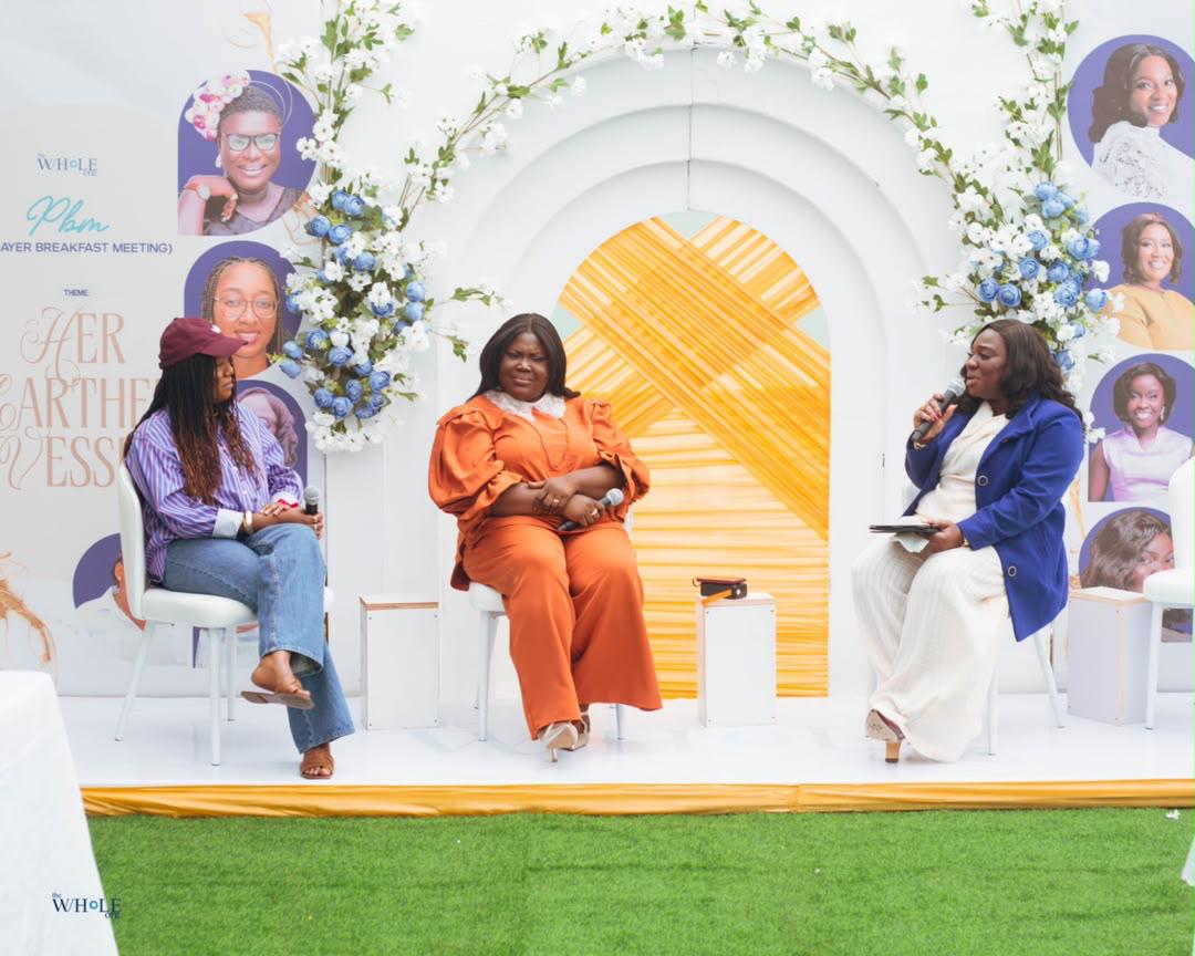 Mercy Sinclear seated on a panel with two other women at a Prayer Breakfast Meeting
