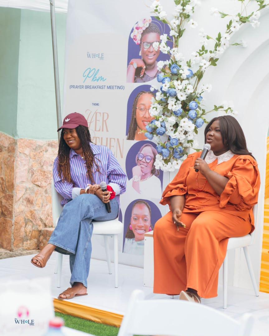 Mercy Sinclear speaking into a microphone during a Prayer Breakfast Meeting conversation